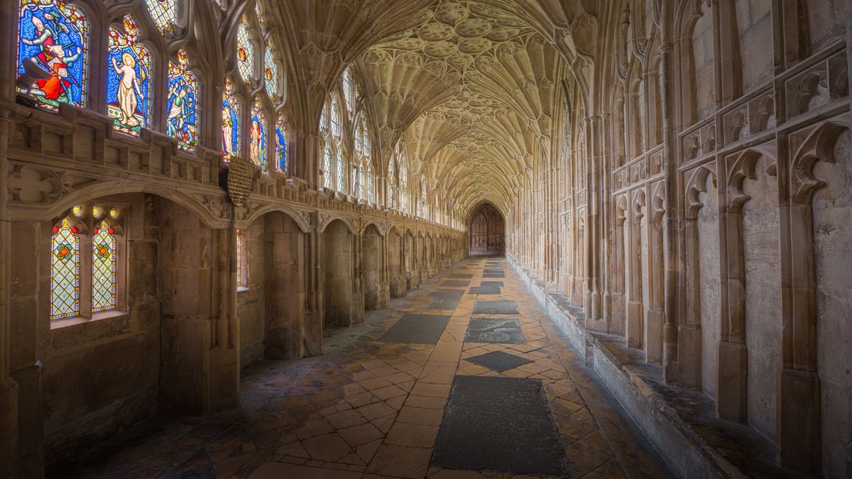 Fan-vaulted cloister with stained glass windows at Gloucester Cathedral