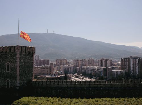 Free Scenic view of Skopje cityscape featuring the Macedonian flag and mountainous backdrop. Stock Photo