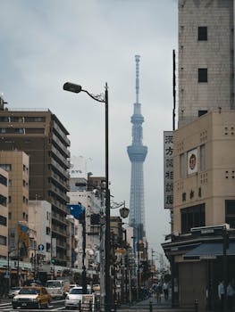 Urban view of Tokyo featuring the iconic Tokyo Skytree Tower amid city streets.