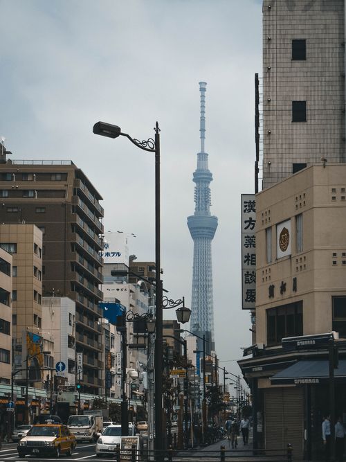 Free Urban view of Tokyo featuring the iconic Tokyo Skytree Tower amid city streets. Stock Photo