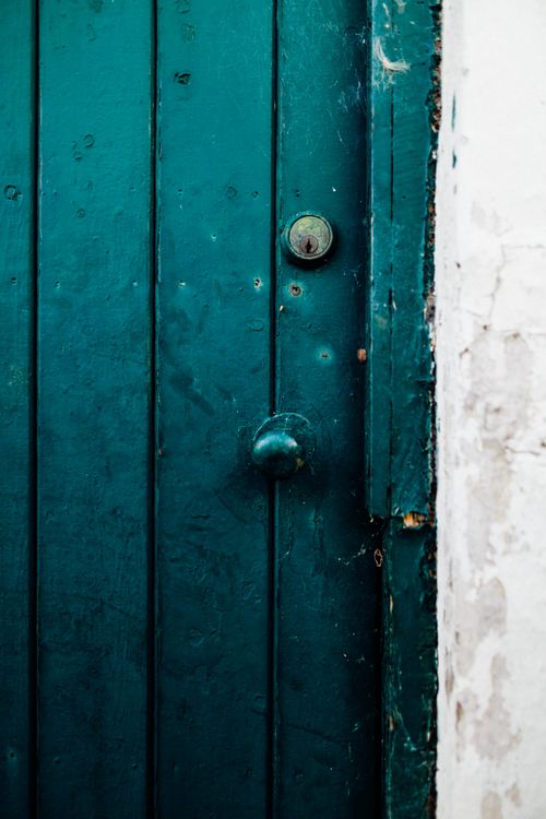 Free Close-up of an aged wooden door with a vintage knob, showcasing texture and rustic charm. Stock Photo