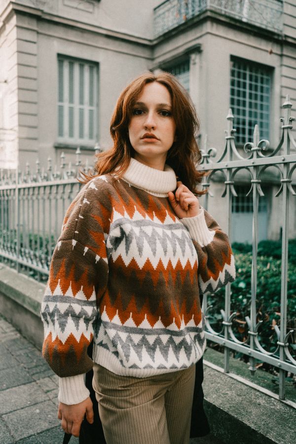 Woman in corduroy pants with a knit sweater in an autumn outfit