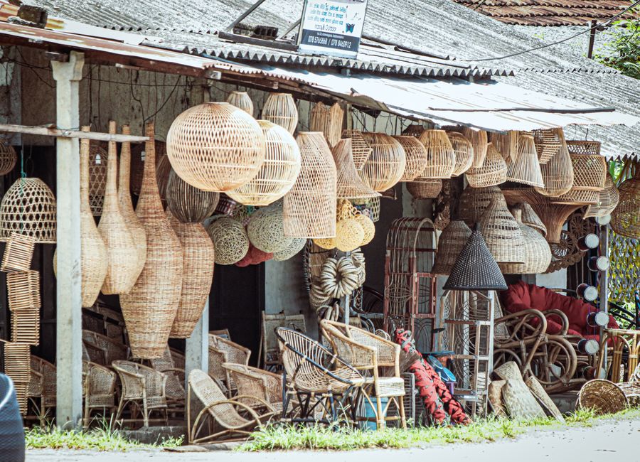 Explore the vibrant display of handmade wicker and rattan crafts at the Weweldeniya market.