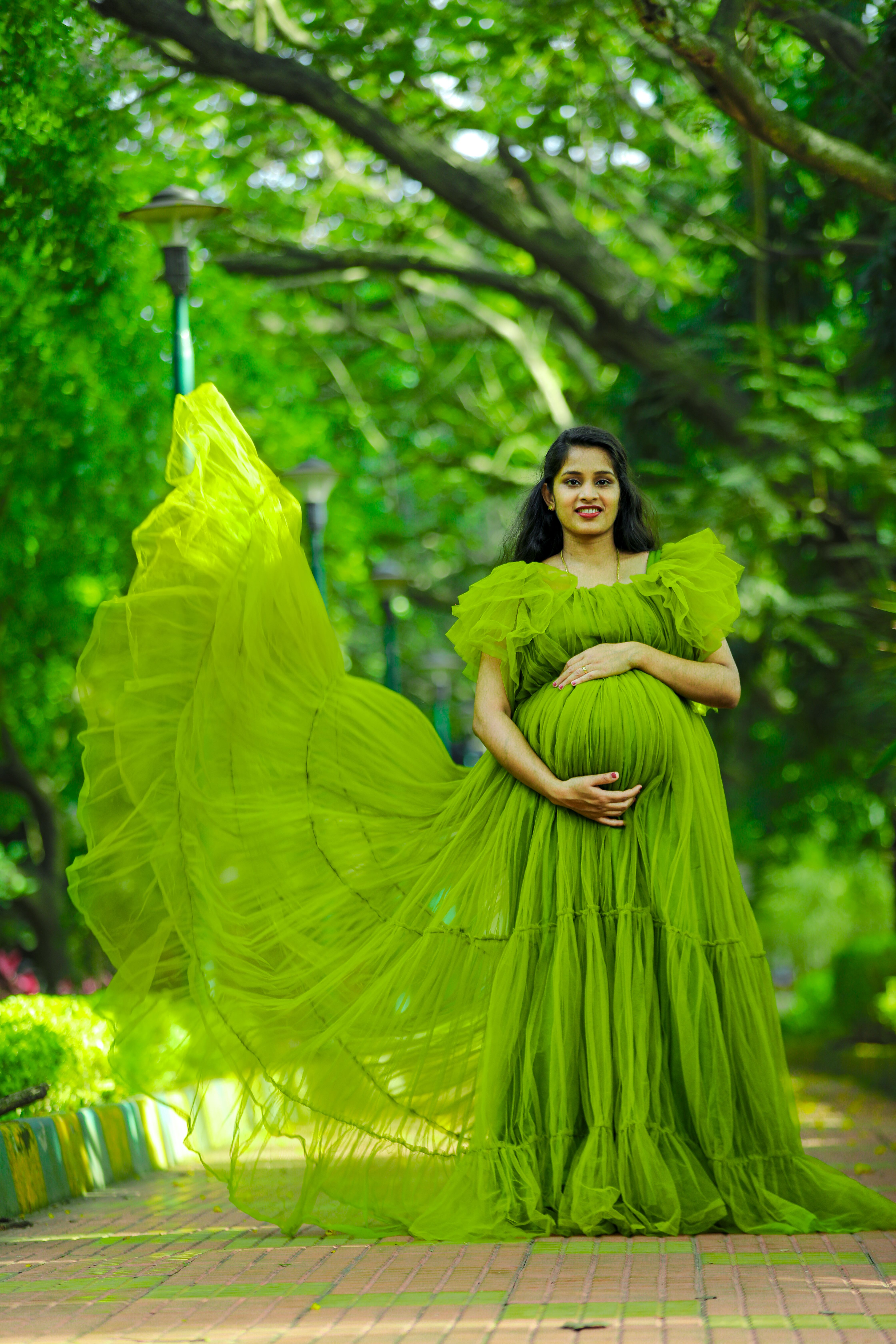 Elegant Maternity Portrait in Lush Green Park  Free Stock Photo