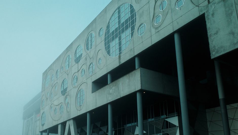 Foggy view of Musikkens Hus in Aalborg, Denmark showcasing modern design.