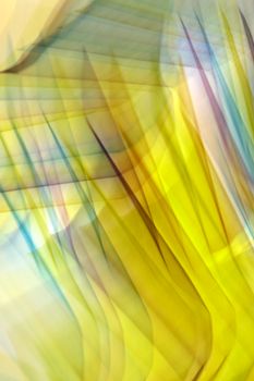 Abstract light streaks in vibrant yellow and blue hues create dynamic motion.