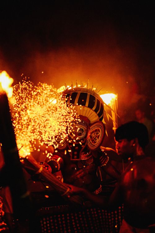 Free Dramatic night shot of a traditional fire dance with ornate costumes and bright flames. Stock Photo