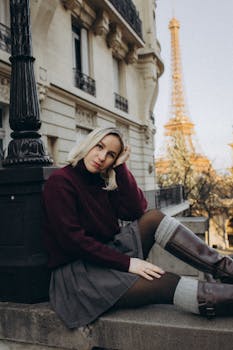 Young woman in chic attire posing near Eiffel Tower. Perfect for travel and lifestyle themes.