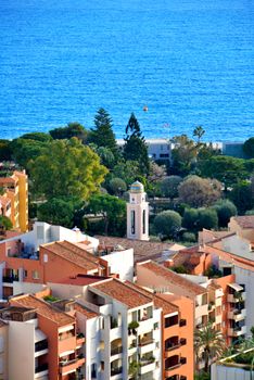 Aerial view of Mediterranean architecture along the coastline with a beautiful blue sea.