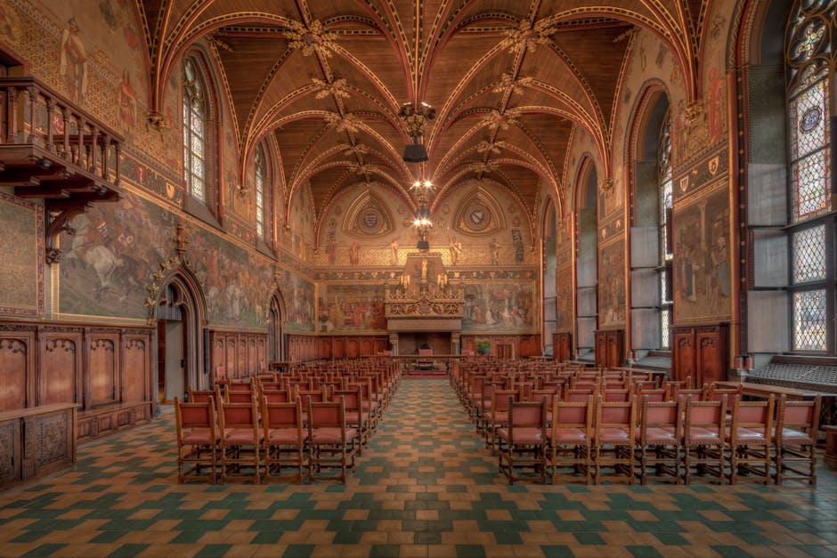 Explore the intricate Gothic architecture of the historic Bruges City Hall interior.