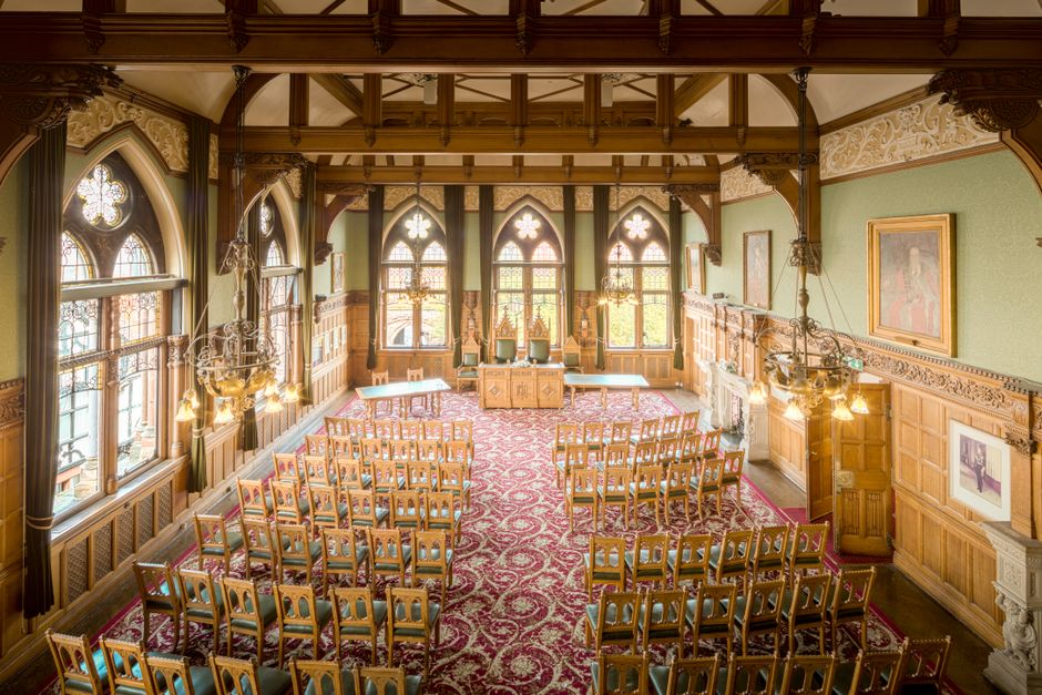 A beautifully ornate town hall interior featuring vintage woodwork and impressive Gothic architecture.