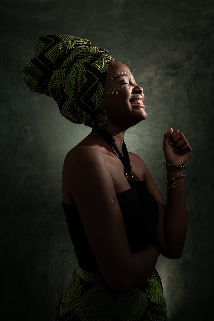 Woman Smiling While Wearing Green Headwear