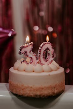 Celebrate the big 3-0 with this elegant birthday cake featuring lit number candles.