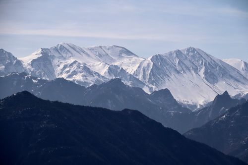 Free Stunning view of a snow-covered mountain range under a clear blue sky. Stock Photo