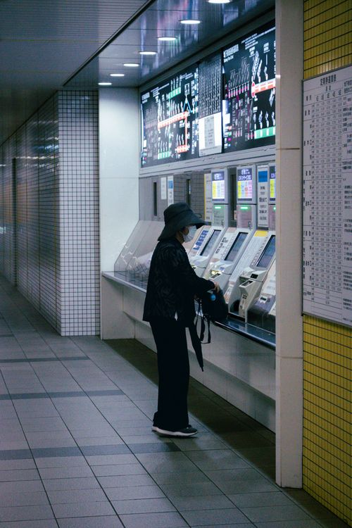 Free Person using ticket machine at an underground metro station in Japan. Clean, modern setting. Stock Photo