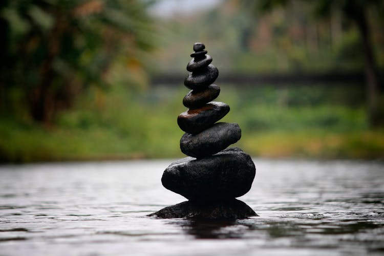 Black Stackable Stone Decor At The Body Of Water