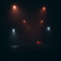 Empty road at night lit by orange street lamps in fog. Photo by Elijah O’Donnell on Pexels.