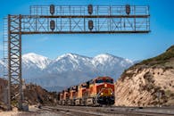 Freight Train Passing Through Mountainous Landscape