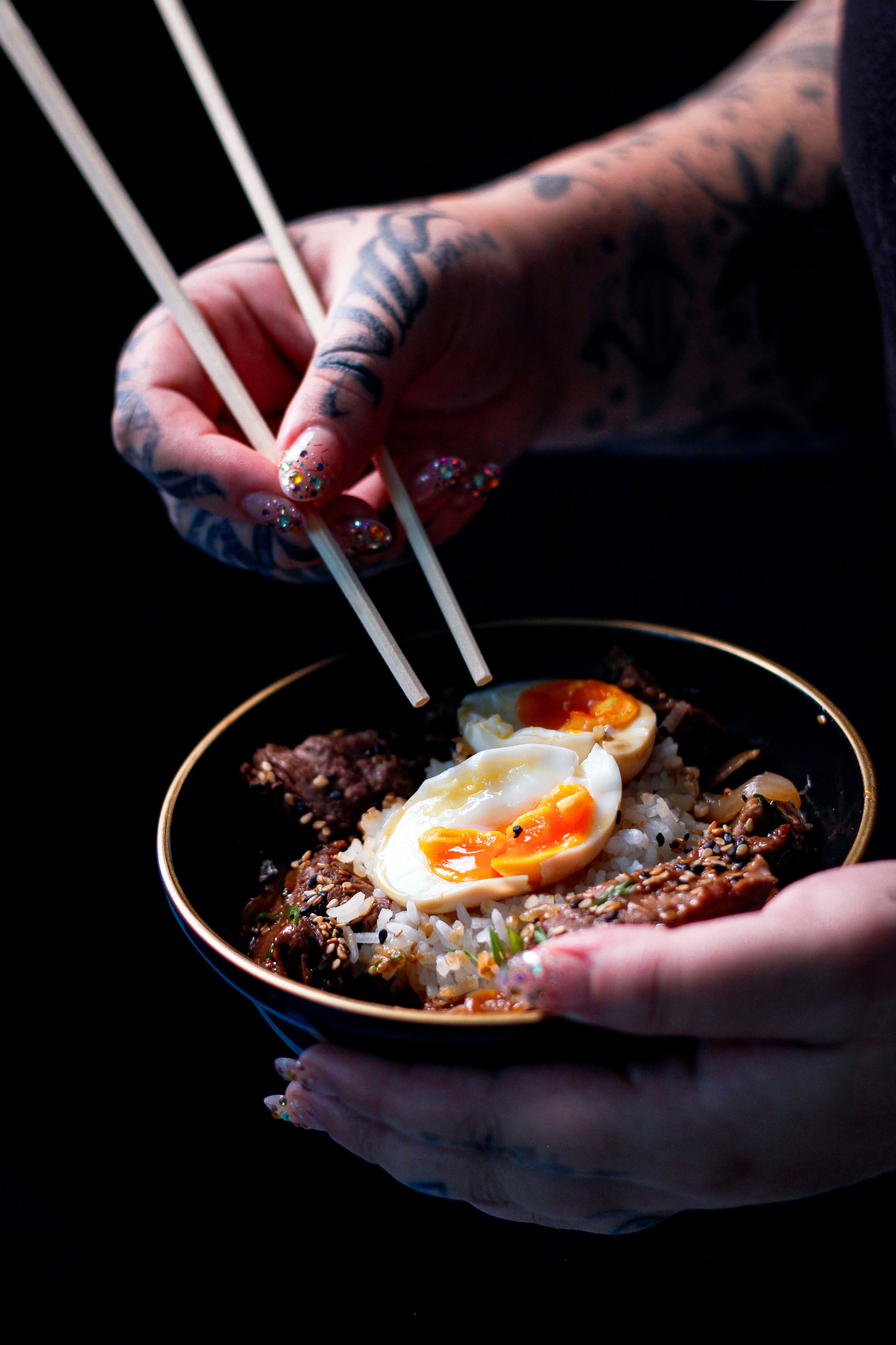 Hands Holding Delicious Asian Rice Bowl with Egg · Free Stock Photo