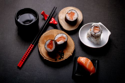 Free Stylish overhead shot of salmon sushi with soy sauce and chopsticks, perfect for culinary use. Stock Photo