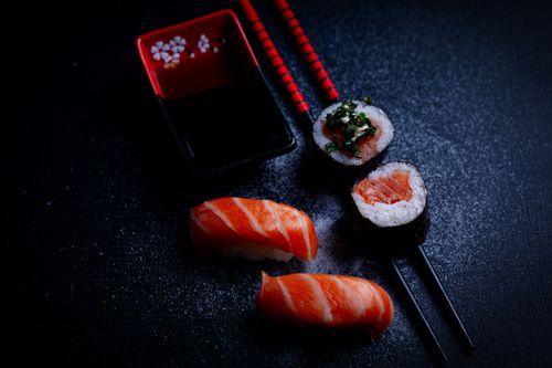 Free High-quality image of salmon nigiri and maki sushi with soy sauce and chopsticks. Stock Photo