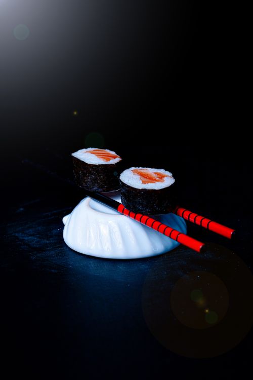 Free Elegant sushi and chopsticks arrangement in a minimalist setting, perfect for food lovers. Stock Photo