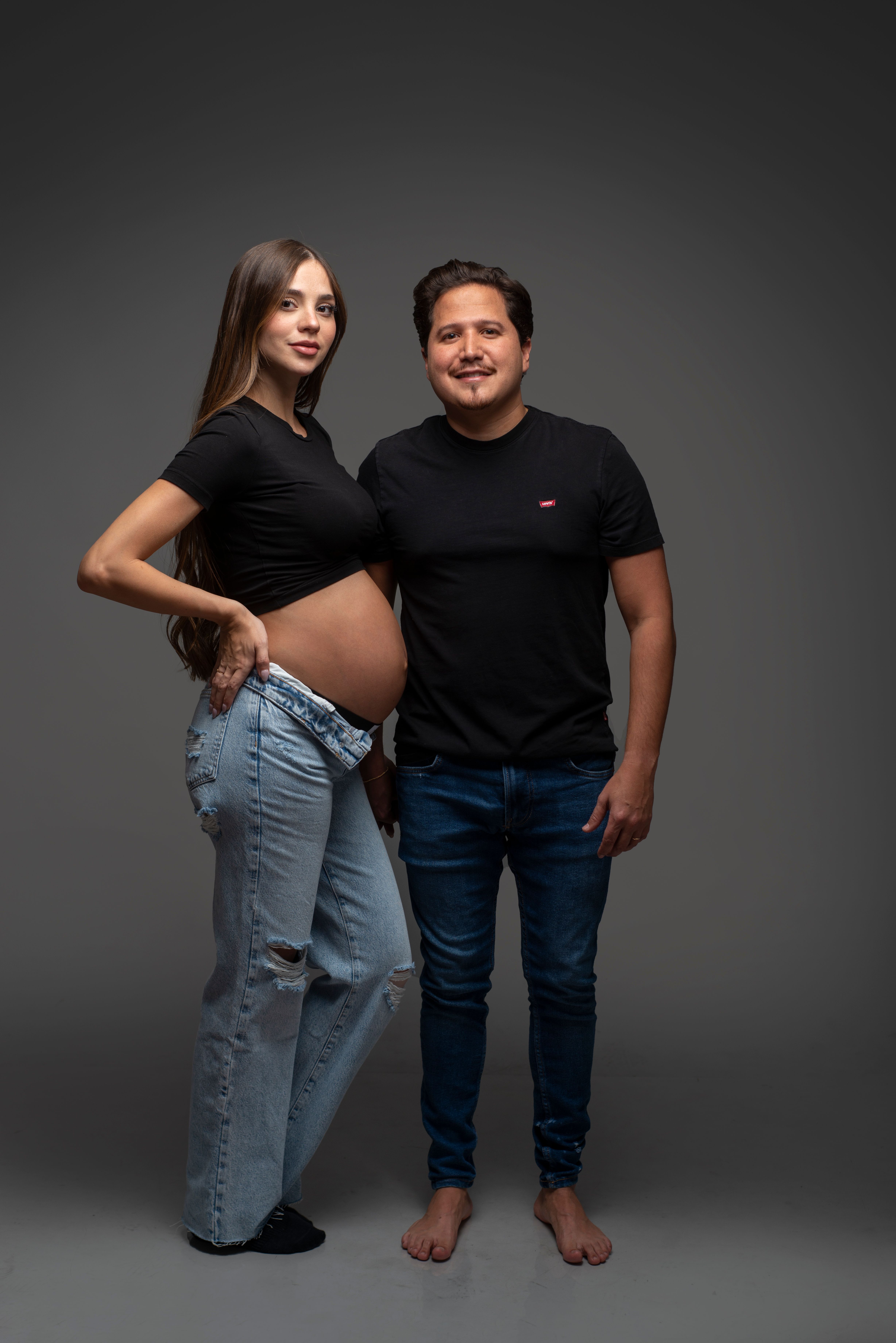Happy Expecting Couple in Studio Portrait · Free Stock Photo