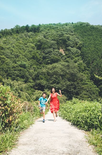 Joyful children running on a forest path. Summer day fun and nature exploration.