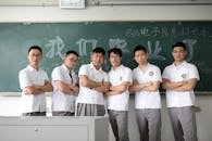 Group of Students in Classroom with Chalkboard