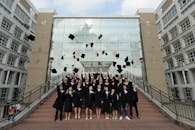 Graduation Day Celebration with Students Tossing Caps
