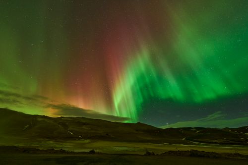 Free Stunning aurora borealis over Icelandic landscape, vibrant colors illuminating the night sky. Stock Photo