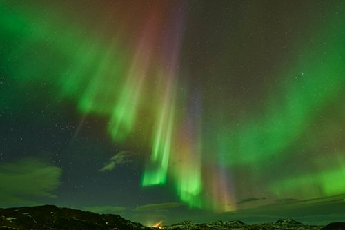 Free Vivid aurora borealis dancing over Icelandic landscape, captivating night spectacle. Stock Photo