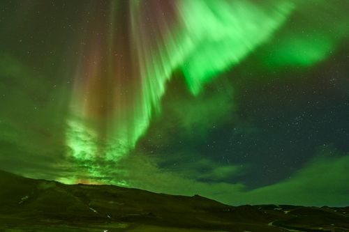 Free Stunning display of the Northern Lights over Reykjahlíð, Iceland's night sky. Stock Photo