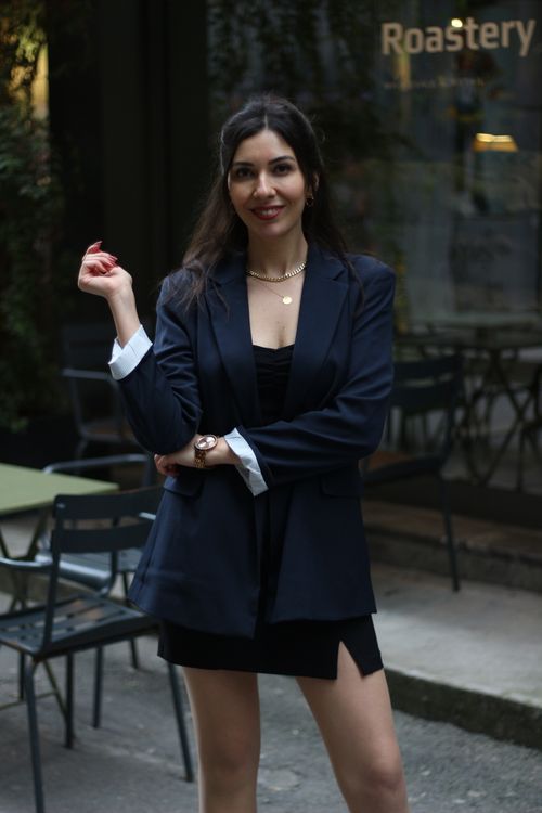 Free Fashionably dressed woman in Istanbul standing confidently outside a roastery. Stock Photo