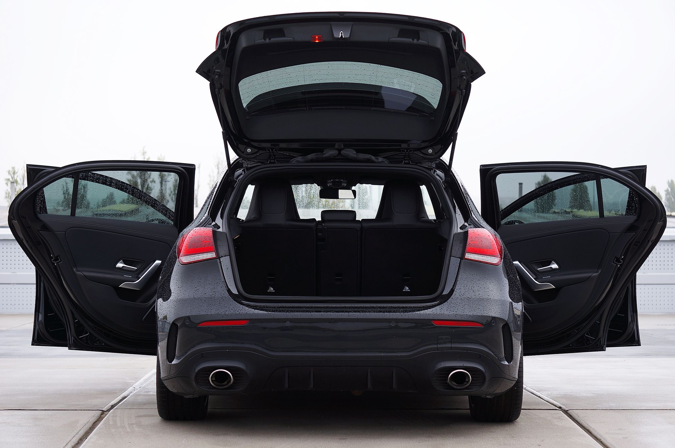 Older Hatchback With Rounded Rear Window Rear view of a luxury hatchback car with open doors · Free Stock Photo