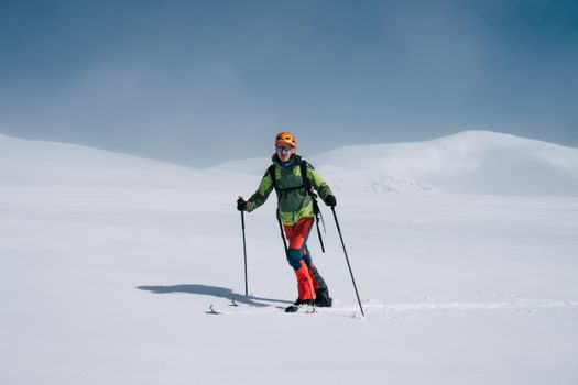 A skier dressed in bright gear on a snowy mountain, showcasing winter adventure.