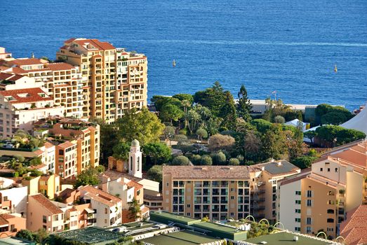 Breathtaking aerial shot of Monaco's coastal buildings against a serene sea backdrop.