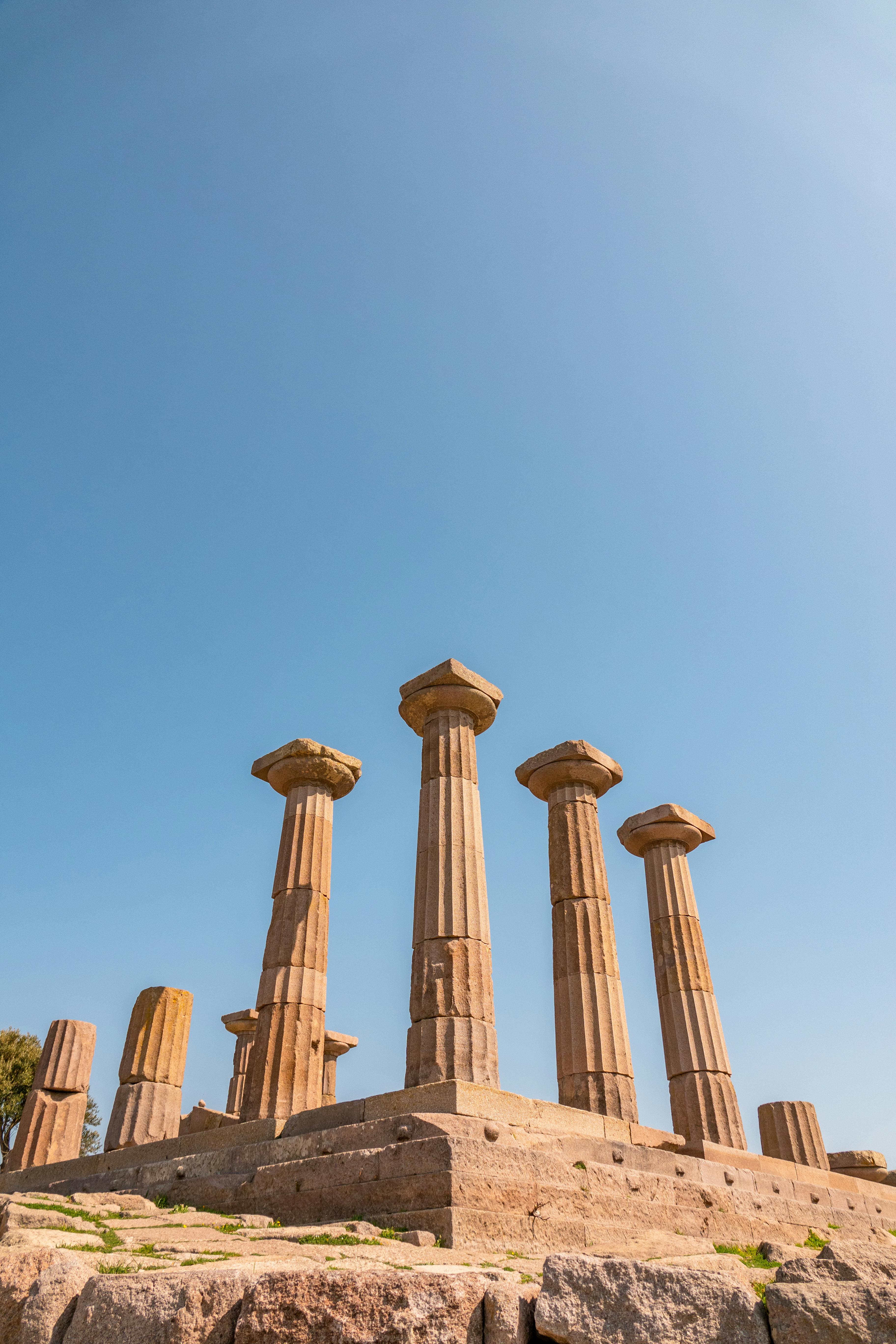 Explore the majestic ancient Greek temple ruins in Behram, Çanakkale under a clear blue sky.