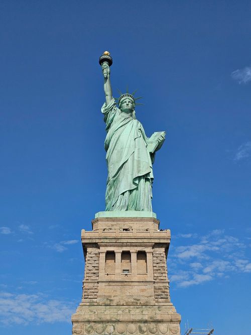 Free Iconic Statue of Liberty on a sunny day in New York City, USA. Stock Photo