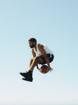 Player mid-air with a basketball — photo by karim Ouakkaha on Pexels