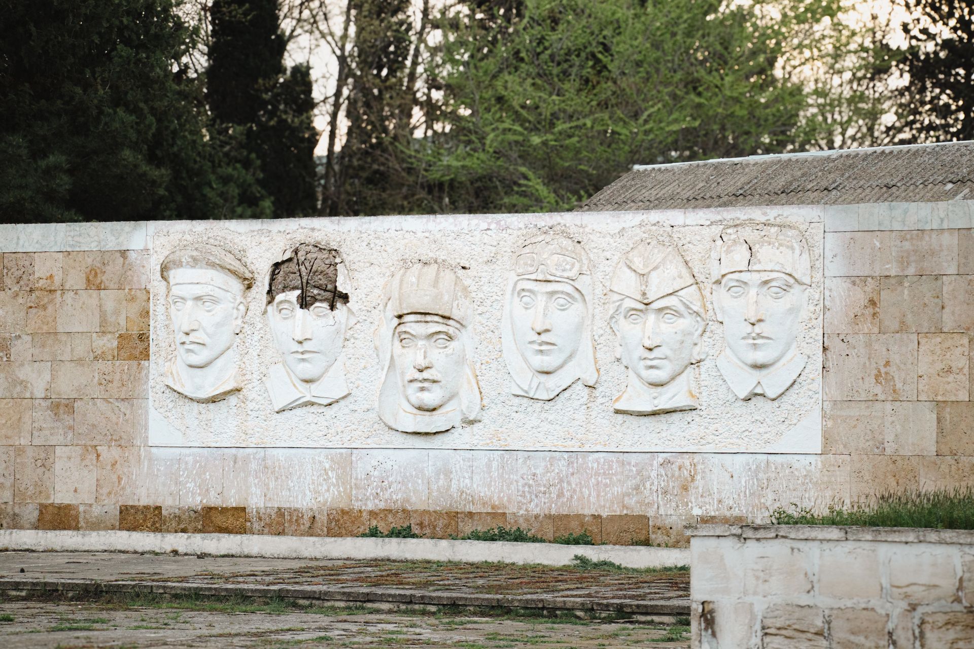Outdoor wall-mounted relief sculpture featuring historical figures in Salyan, Azerbaijan.