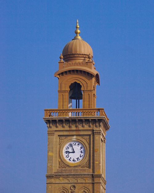 Free Classic clock tower with golden dome in Mysuru, India against clear blue sky. Stock Photo