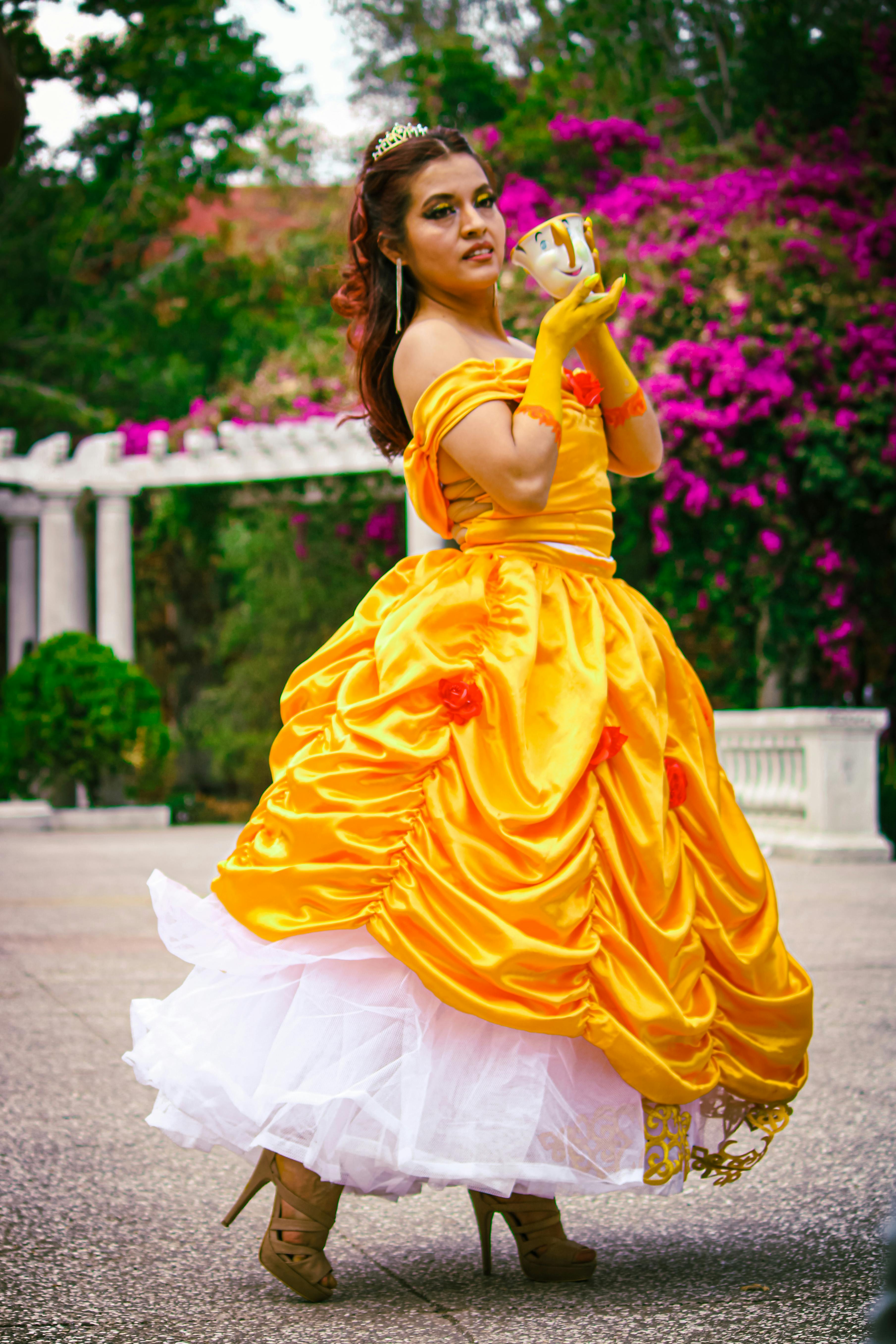 Actress portraying Belle in Beauty and the Beast costume on stage
