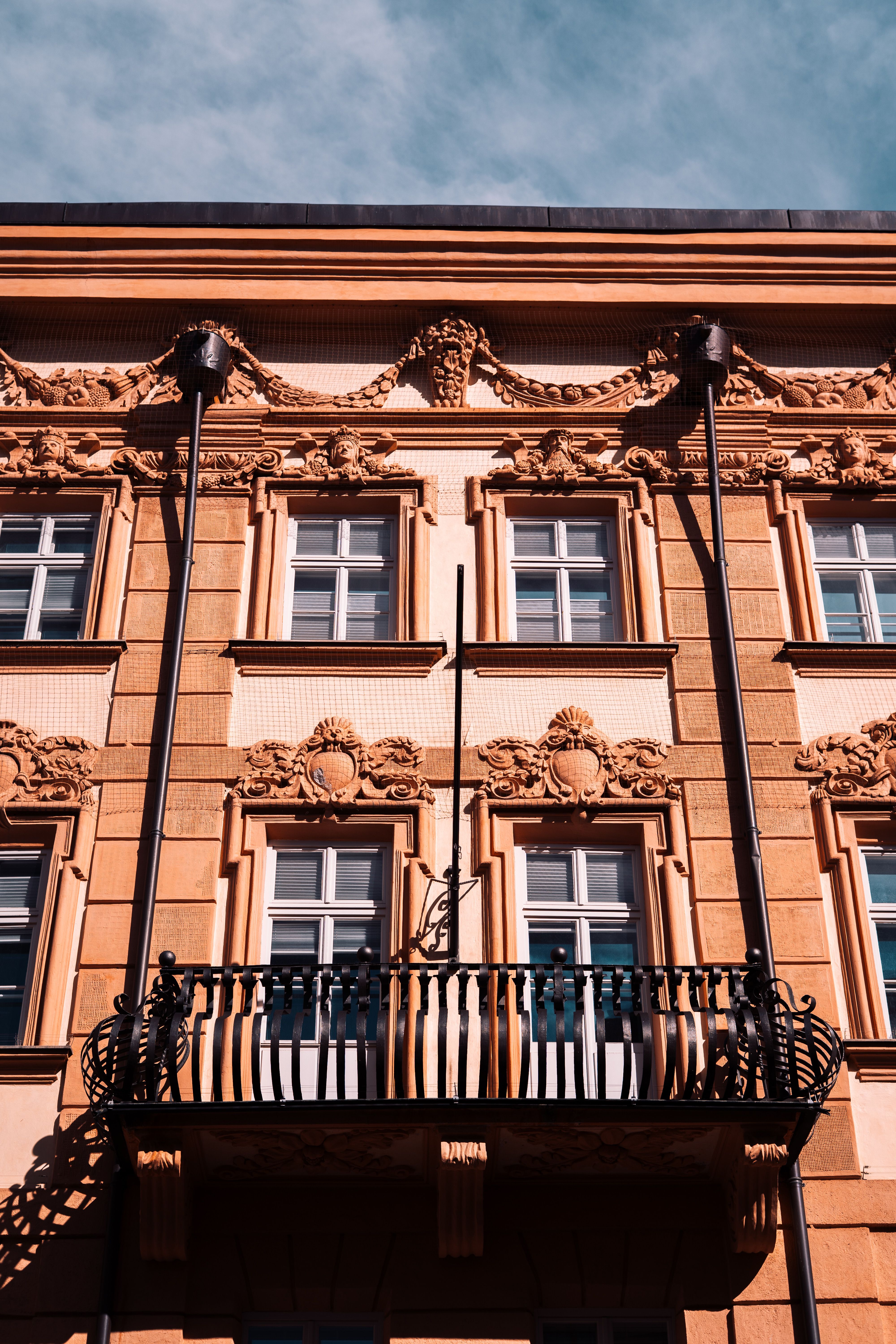 Ornate European Building Facade with Balcony · Free Stock Photo