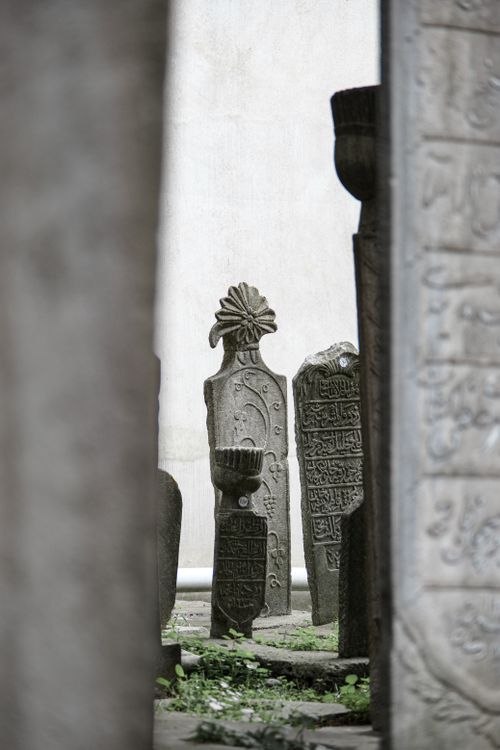 Free Close-up of ornate stone tombstones in a historic cemetery, showcasing intricate carvings. Stock Photo