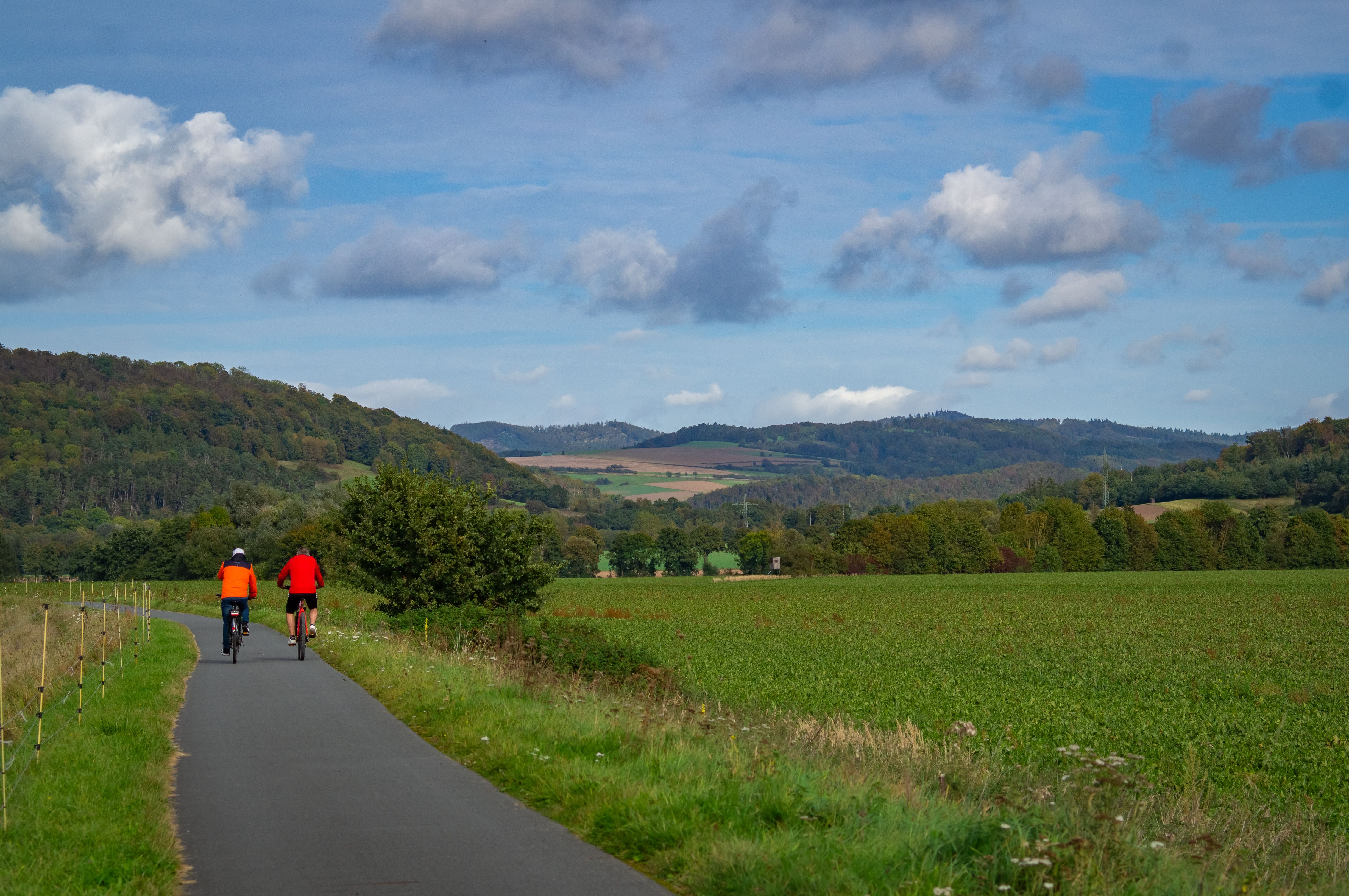Cyclists Exploring Scenic Countryside Path in Autumn · Free Stock Photo