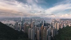 从高处欣赏香港壮丽的天际线，摩天大楼耸立在多云的天空下