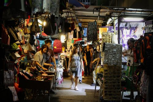 Free Vibrant scene of people shopping in a lively Hong Kong Island night market. Stock Photo