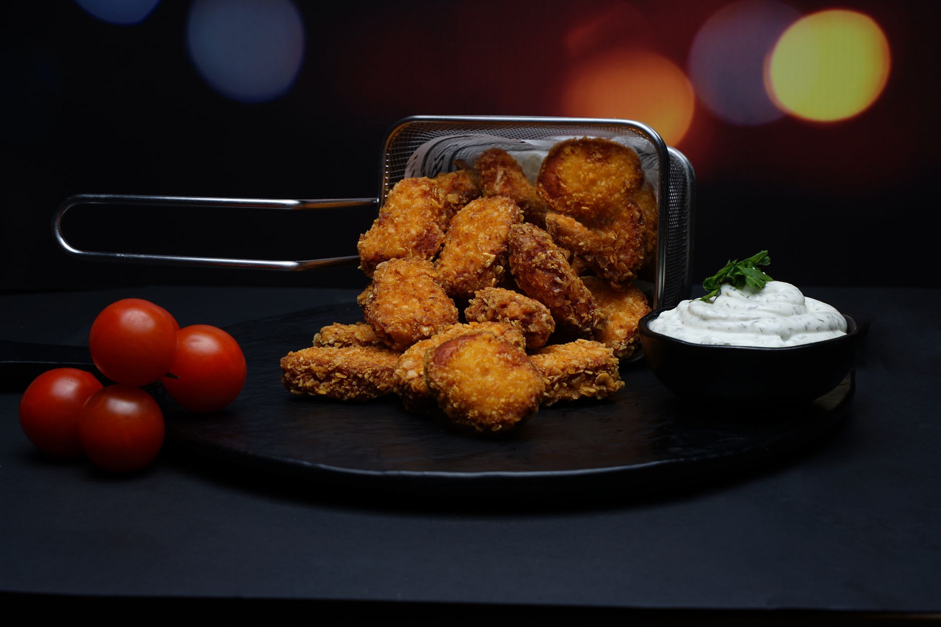 Plate of crispy golden frozen chicken nuggets with dipping sauce