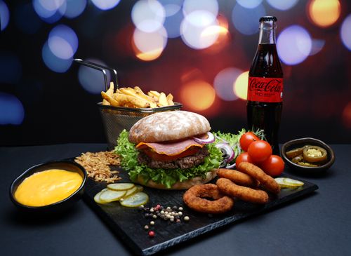 Free A scrumptious burger meal with fries, cheese sauce, and soda, perfect for a feast. Stock Photo